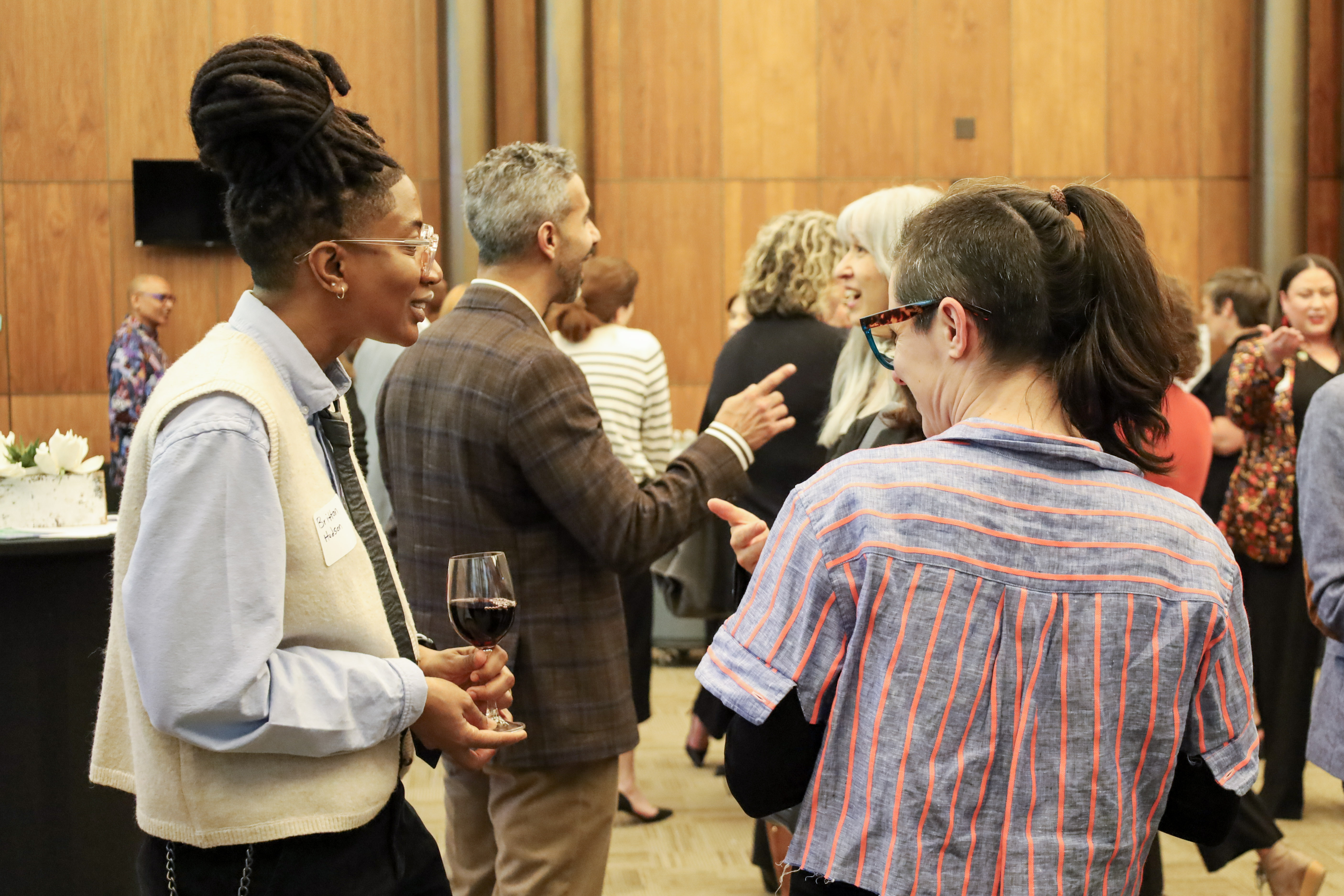 Two people engaged in a lively conversation at the Fair Funding Hill Day Reception
