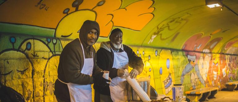 Two men serving food