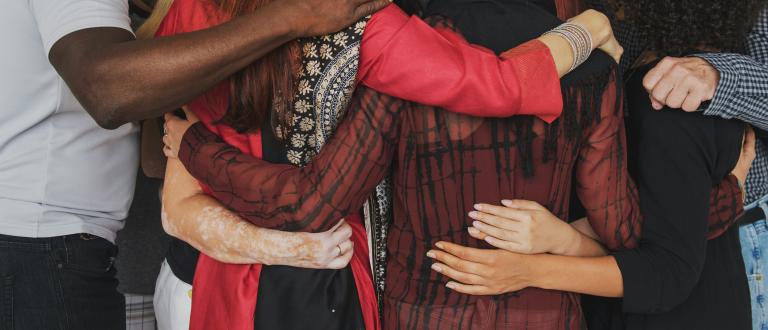 Group of people huddle together