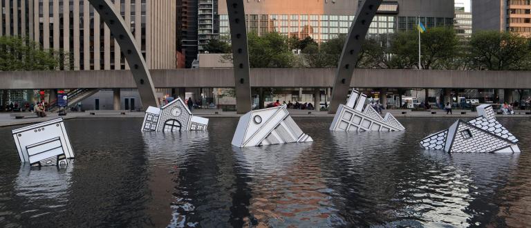 Taking the city by surprise, a two-in-one art installation has drifted into Nathan Philips Square this week. Half icebergs, half remnants of civilization, these resin sculptures are meant to represent the negative ramifications of the melting polar ice caps.