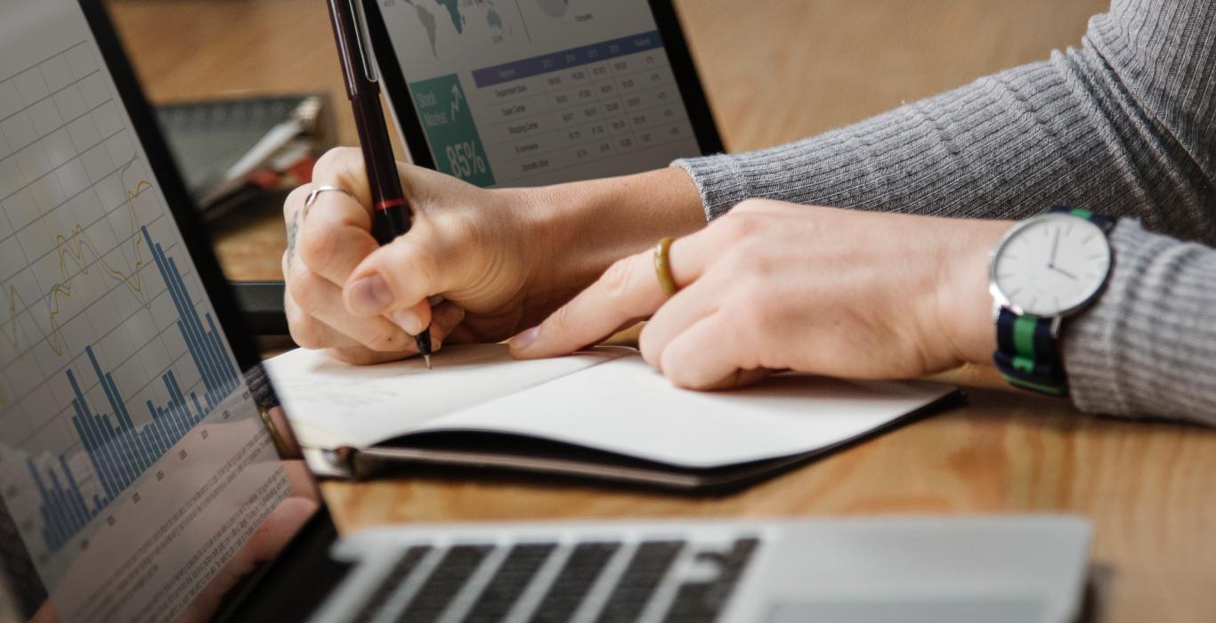 Image of person writing in a note book