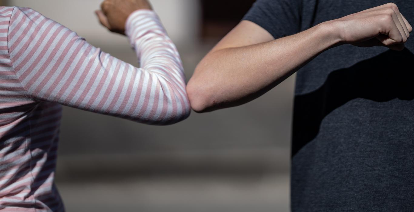 two people elbow bumping