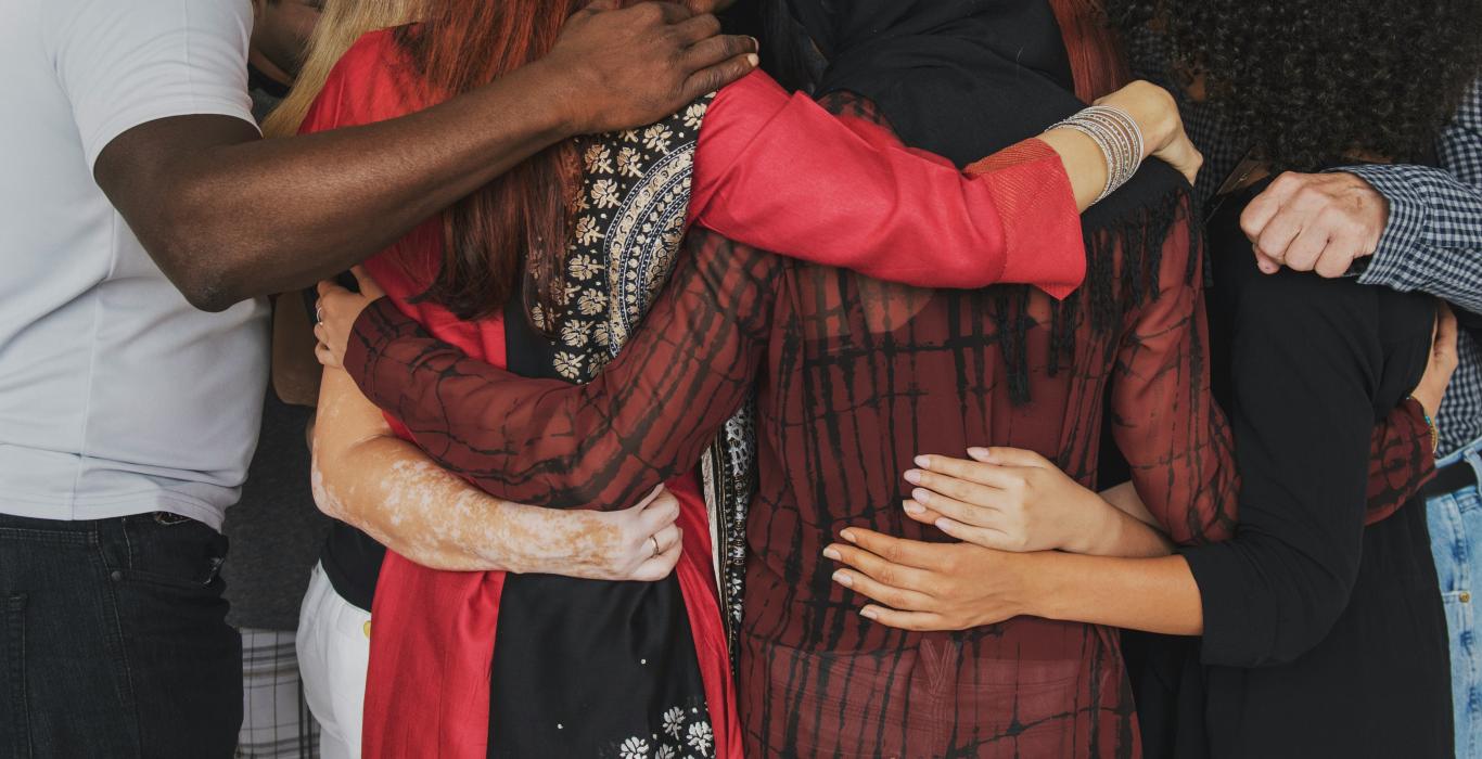 Group of people huddle together