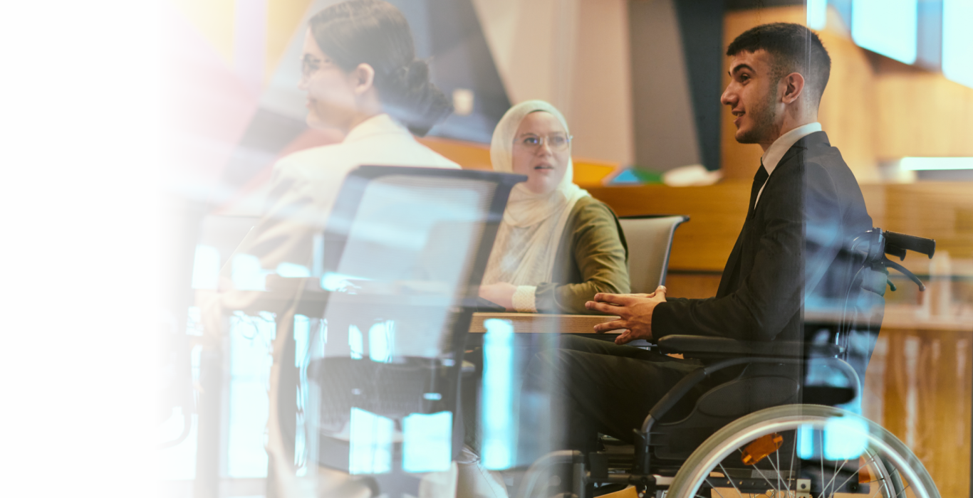 Image: A group of professionals in a modern office setting engaged in a discussion.