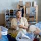 Volunteers sorting and discussing clothing donations.